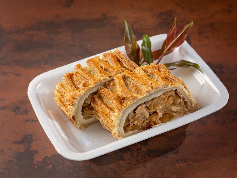 Slices of golden apple strudel on a white plate.
